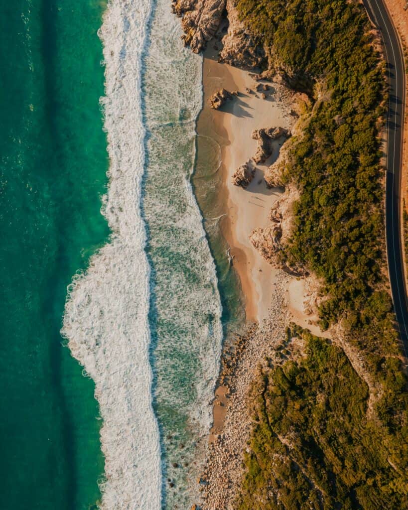 Scenic South Africa coast with waves and rocky shoreline.