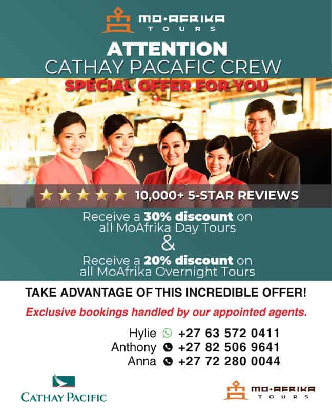 Cathay Pacific crew members with Moafrika Tours promotional banner.