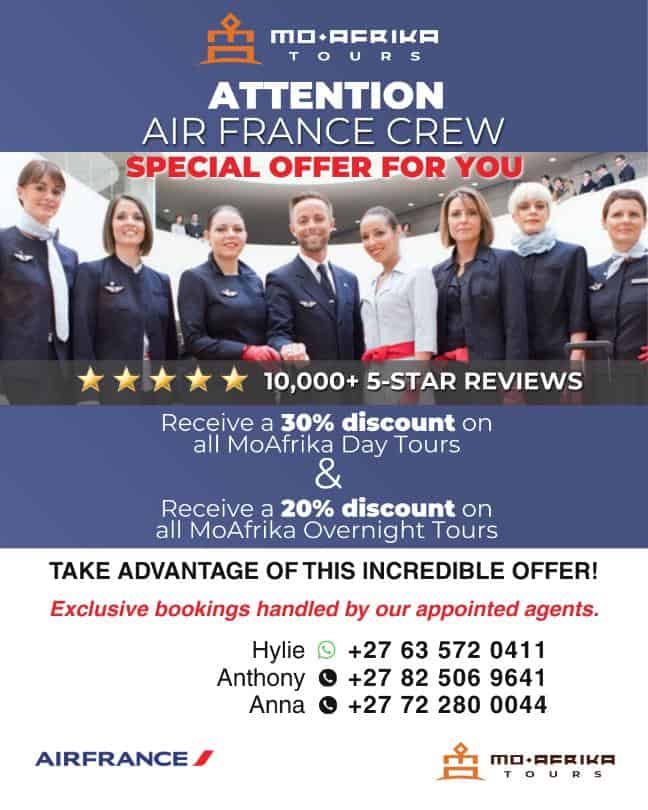 Air France crew members with Moafrika Tours promotional banner for airline staff discounts.