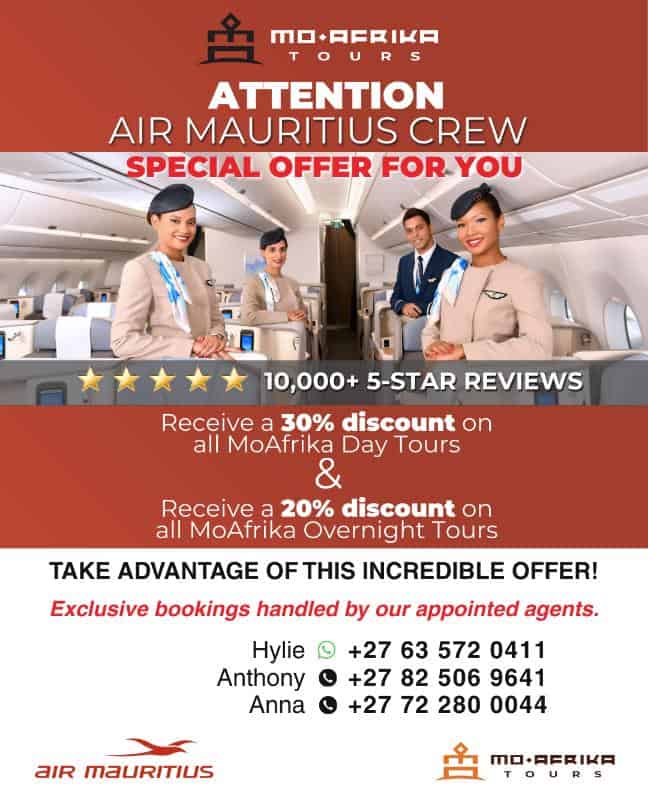 Air Mauritius crew members in uniform onboard aircraft with promotional message.