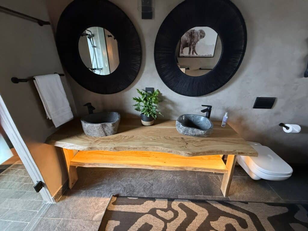 Elegant bathroom with two stone sinks, mirrors, and modern decor.