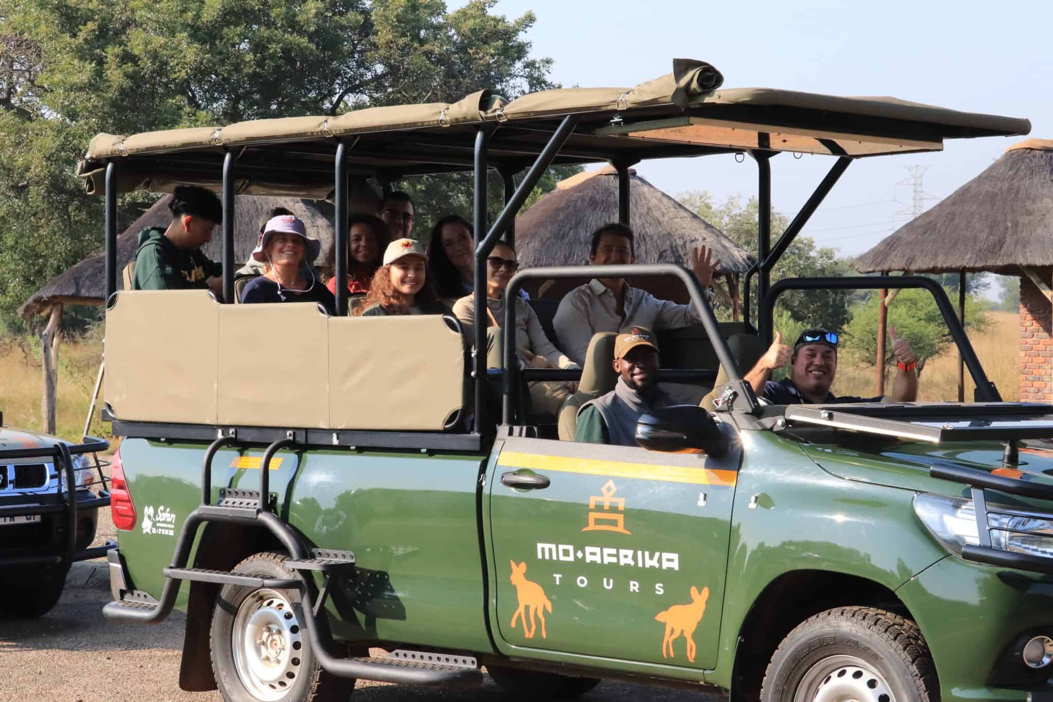 Group of tourists on a safari vehicle in Pilanesberg National Park.