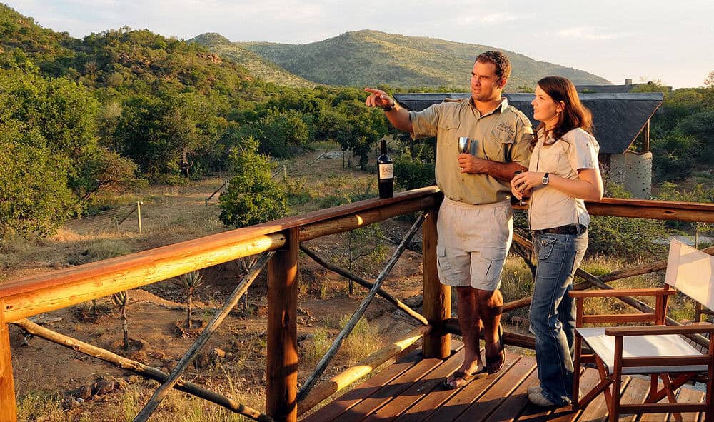 Couple enjoying wine and sunset view during a Pilanesberg safari tour.